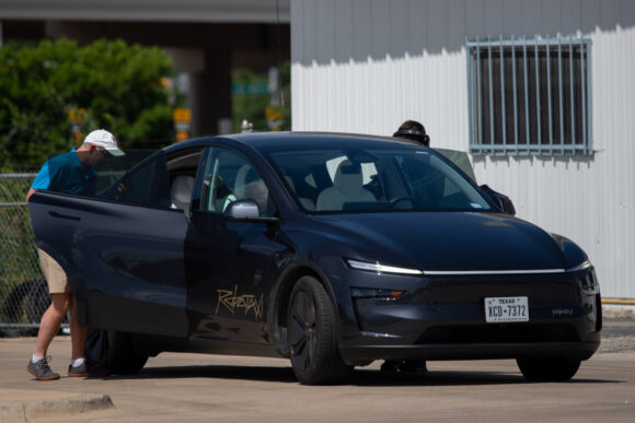 Source-feed image associated with Tesla’s Robotaxi Falls Short With Long Waits and Stalled Rides