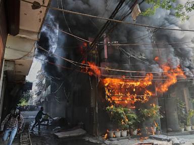 Source-feed image associated with Fire sweeps through New Delhi building, killing at least 18 people