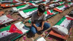 Source-feed image associated with Mass funeral in Gaza for 112 Palestinians killed in 2023 Israeli strike