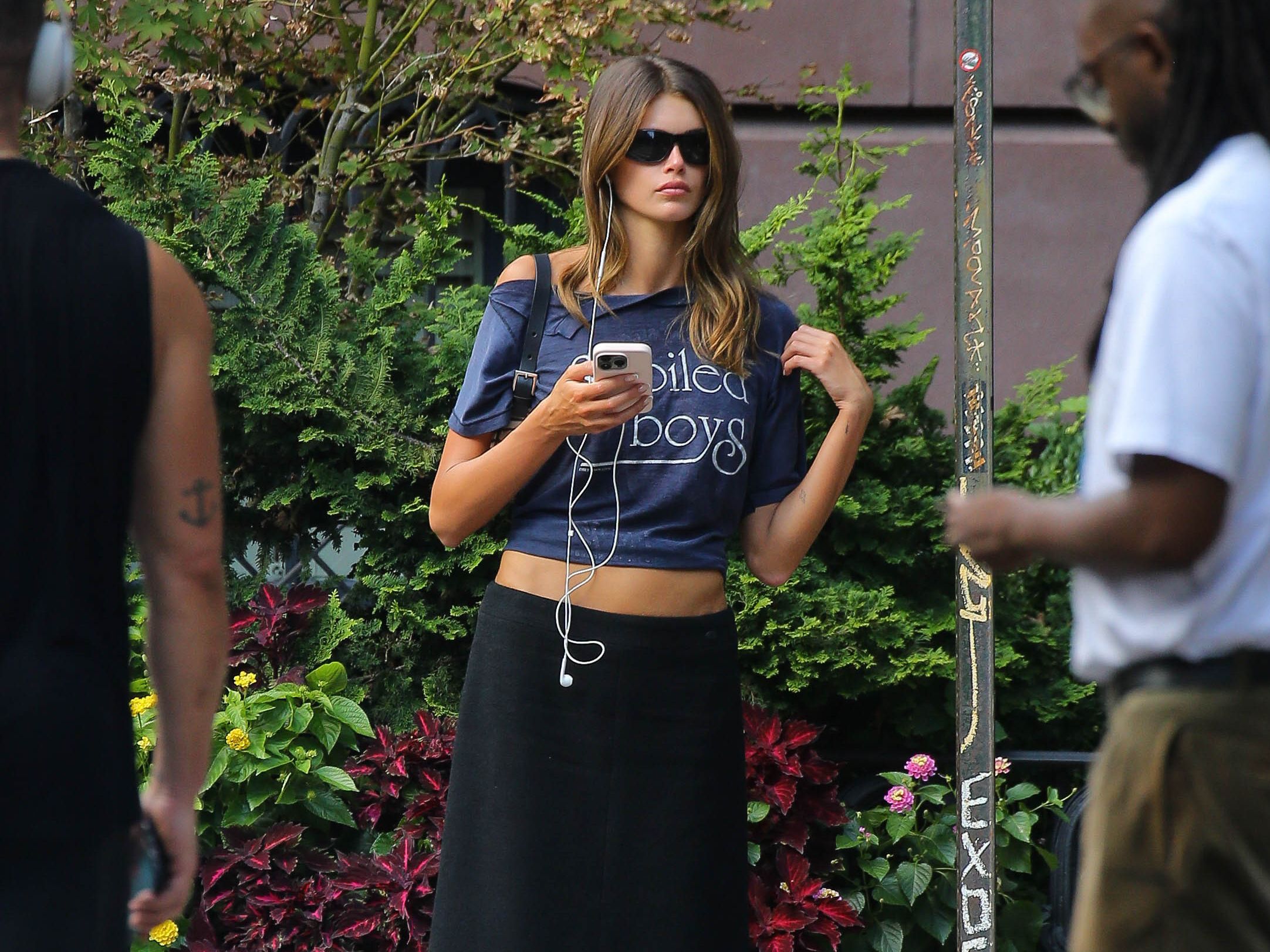 Source-feed image associated with Kaia Gerber Steps Out in a IYKYK Fashion Tee