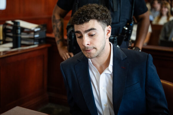 Source-feed image associated with Insurer CEO Shooting Suspect Mangione’s Federal Trial Delayed Until After State Trial