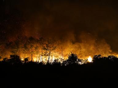 Source-feed image associated with A wind-fueled wildfire forces hundreds from homes in Turkey as firefighters battle flames