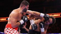 Source-feed image associated with British heavyweight Moses Itauma stretchered out after shock defeat in gruelling world title fight