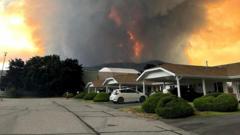 Source-feed image associated with 'We've had a lot of close calls': Canada wildfire evacuees wonder if they still have homes