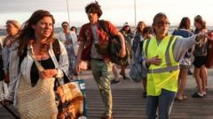 Source-feed image associated with Tourists tell BBC how their holiday turned into race to escape fires