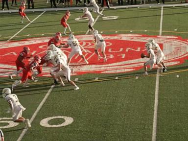 Source-feed image associated with WATCH: Two towns, scarred by fire, unite on the football field