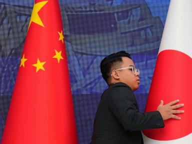 Source-feed image associated with Japan protests as China slaps new measures against exports of key chipmaking material