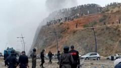 Source-feed image associated with Watch: Moroccan police clash with migrants near border with Spain's Ceuta