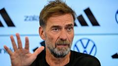 Source-feed image associated with Jurgen Klopp starts his new job as Germany's head coach by threatening to quit