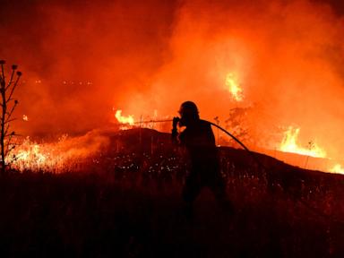 Source-feed image associated with A fast-moving wildfire near Greece's Thessaloniki sparks evacuations as smoke blankets suburbs