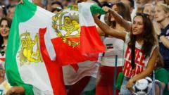 Source-feed image associated with Iran v Iran in the stands in LA as politics and football intertwine