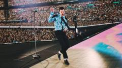Source-feed image associated with Harry Styles receives Guinness World Record for longest Wembley Stadium run