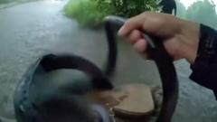 Source-feed image associated with Watch: Texas police rescue baby from car stuck in floodwater