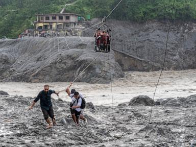 Source-feed image associated with Trading food for medicine and crossing the river by zip line are part of life in Nepal flood zone