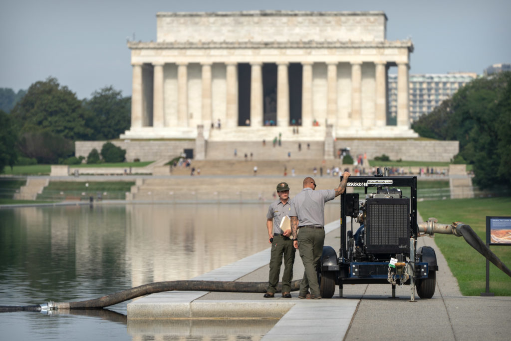 Source-feed image associated with Crews are draining the Lincoln Memorial Reflecting Pool again as part of Trump's troubled revamp