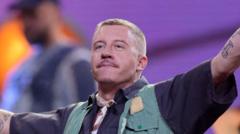 Source-feed image associated with Macklemore dropped from Ed Sheeran tour after 'Free Palestine' speech