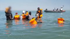 Source-feed image associated with Watch: BBC witnesses 'taxi boat' picking up migrants multiple times in a day