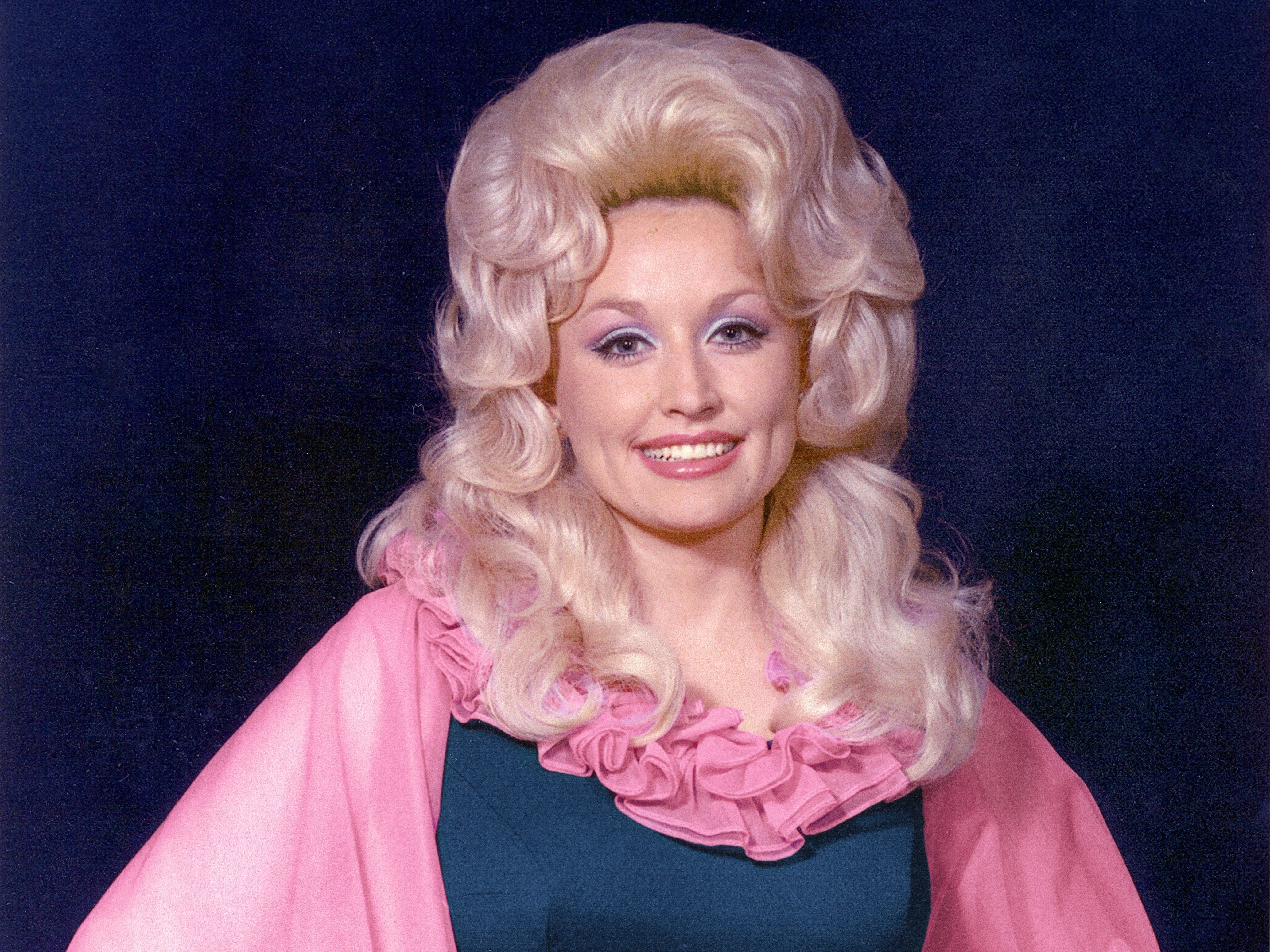 Source-feed image associated with Dolly Parton Shares Her Six Fashion Rules