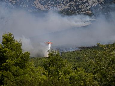 Source-feed image associated with 2 killed when firefighting helicopters collide near Athens as Europe’s wildfire emergency rages