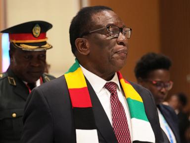Source-feed image associated with Zimbabwe's 83-year-old president signs law to delay elections and extend his own term