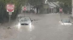 Source-feed image associated with Flash flooding interrupts half-marathon, submerges cars