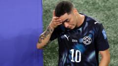 Source-feed image associated with Paraguay's Almiron first player sent off for covering mouth
