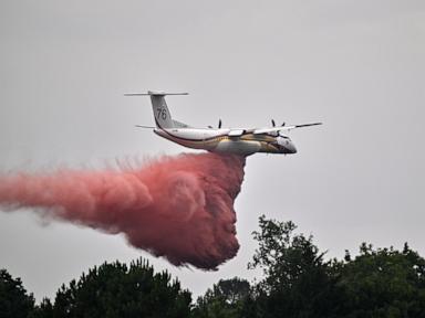 Source-feed image associated with France says monster fire that forced 220,000 people to flee has stopped growing