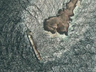 Source-feed image associated with Oman says the oil spill from a grounded tanker has reached its coastline
