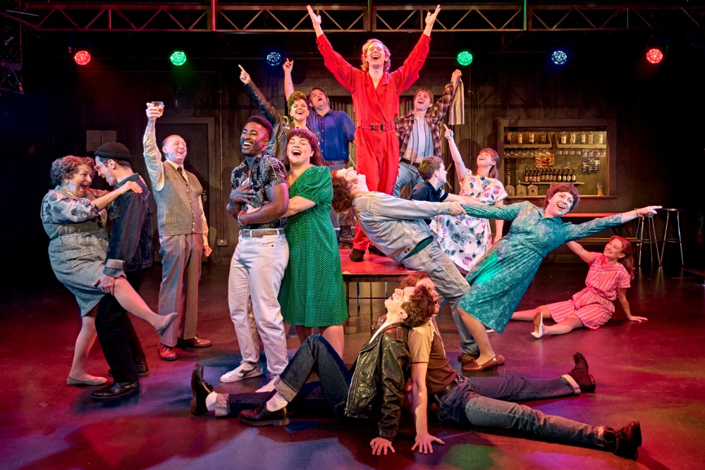 Source-feed image associated with ‘Pride’ Musical to Transfer to Bridge Theatre From November; Director Says Bigger Venue Means the ‘Comedy Will Really Benefit From More People Watching’