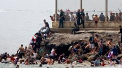Source-feed image associated with Spain sending troops as thousands enter enclave of Ceuta from Morocco