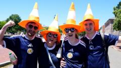 Source-feed image associated with Why are Scotland fans putting traffic cones on statues in Boston?
