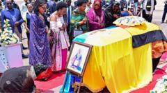 Source-feed image associated with Body of world's youngest traditional king returns home to Uganda amid succession row