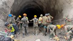 Source-feed image associated with Nepal rescuers blast hillside in search of hydropower workers as families wait anxiously
