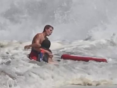 Source-feed image associated with WATCH: Lifeguard fights to rescue boy caught in high surf