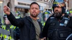 Source-feed image associated with What we know about anti-migrant protests and organiser Danny Thomas
