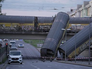 Source-feed image associated with 2 freight trains collide in Germany, sending 2 wagons plunging off bridge; 1 dead