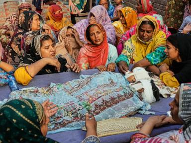 Source-feed image associated with Mourners attend funerals for 14 Pakistani children killed in roof collapse