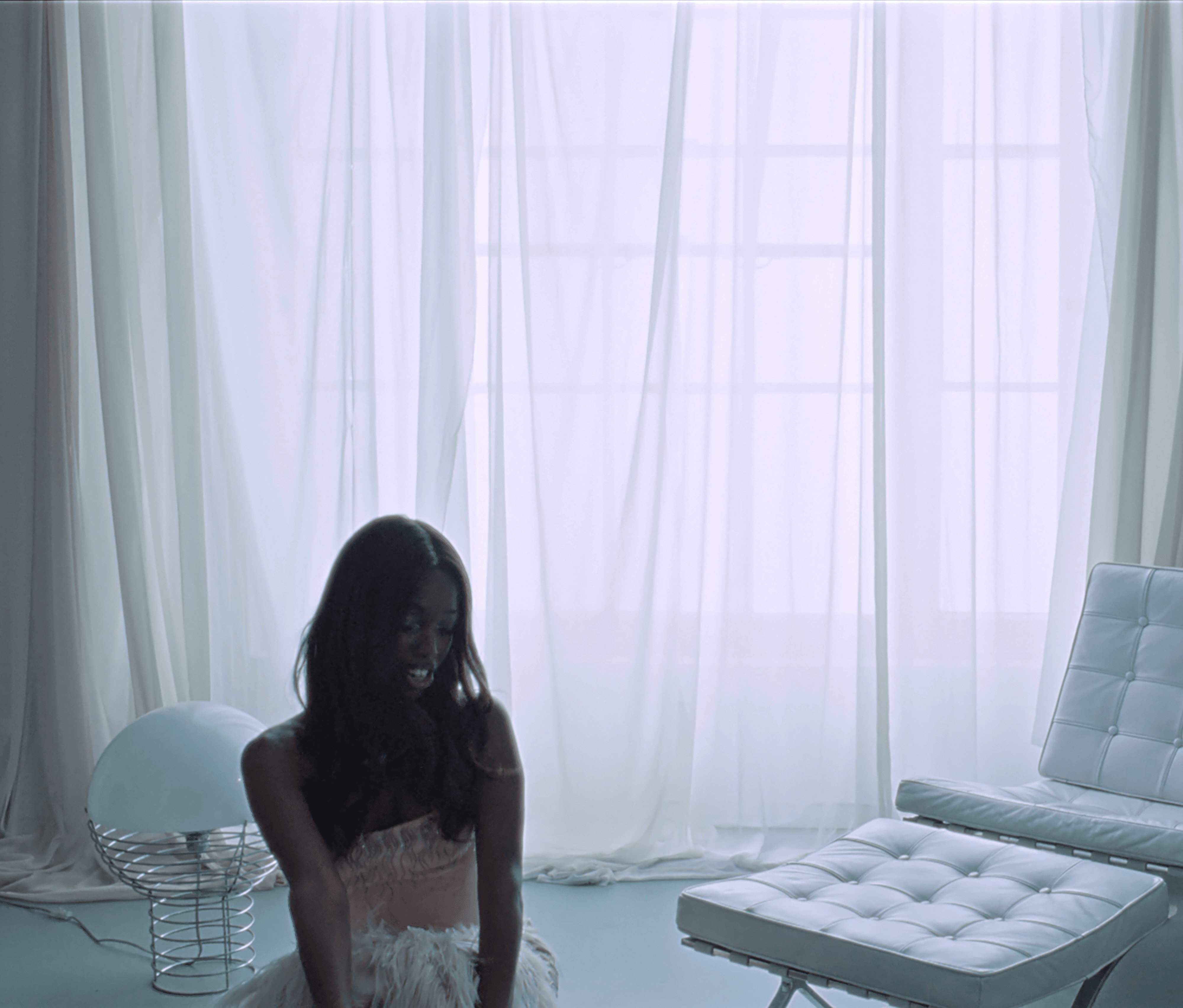 Source-feed image associated with Watch John Glacier Live Out Her 007 Fantasies in New “Bond Girl” Video