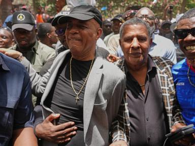 Source-feed image associated with Sanctioned former president Michel Martelly returns to Haiti as some cheer