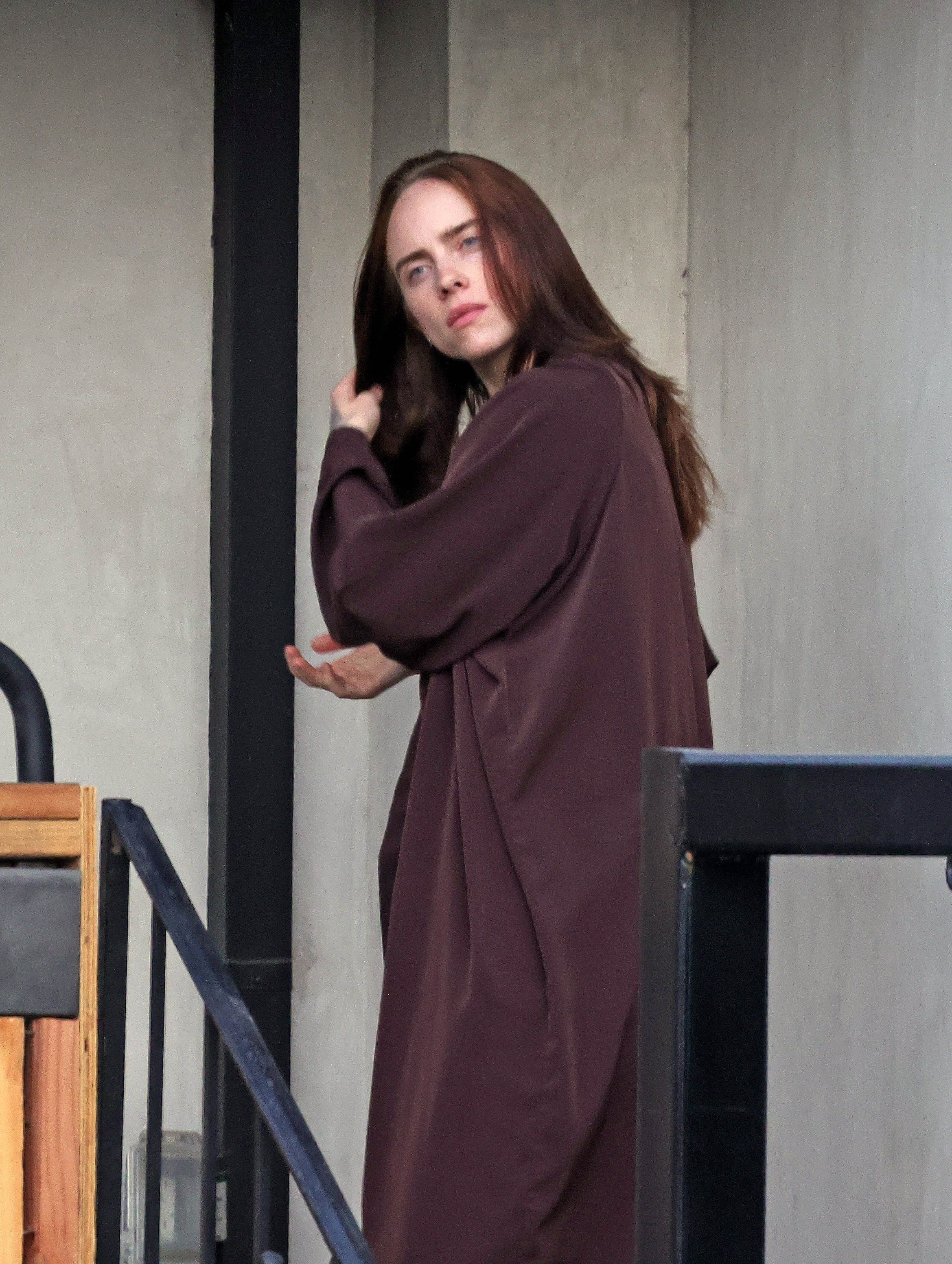 Source-feed image associated with Seeing Red! Billie Eilish Ditches Her Signature Dark Hair for Summer