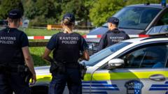 Source-feed image associated with Manhunt after shooting at Swiss rave kills woman, 22, and injures five