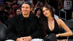 Source-feed image associated with Pop star Madison Beer and NFL player Justin Herbert announce engagement