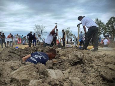 Source-feed image associated with Competitors dig deep in Hungarian grave-digging contest
