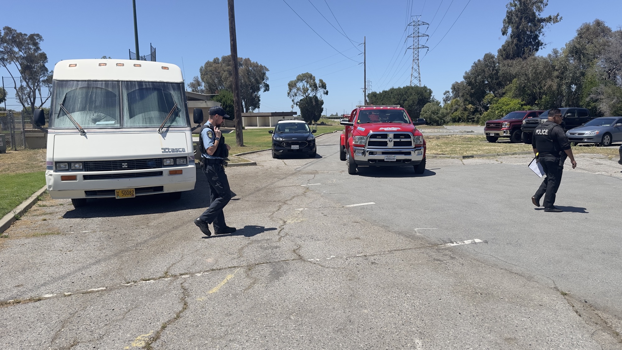 Palo Alto police, a tow truck, and an RV at a parking lot scene on June 1, 2026